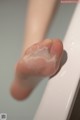 A close up of a person's foot in a bathtub.