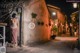 A naked woman standing in the middle of a street at night.