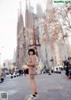 A woman standing in front of a large cathedral.