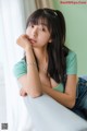 A woman sitting on top of a white couch.