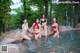 A group of women in bikinis sitting in a pool of water.