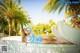 A woman laying on the edge of a swimming pool.