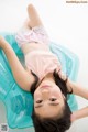 A young girl laying on an inflatable pool float.